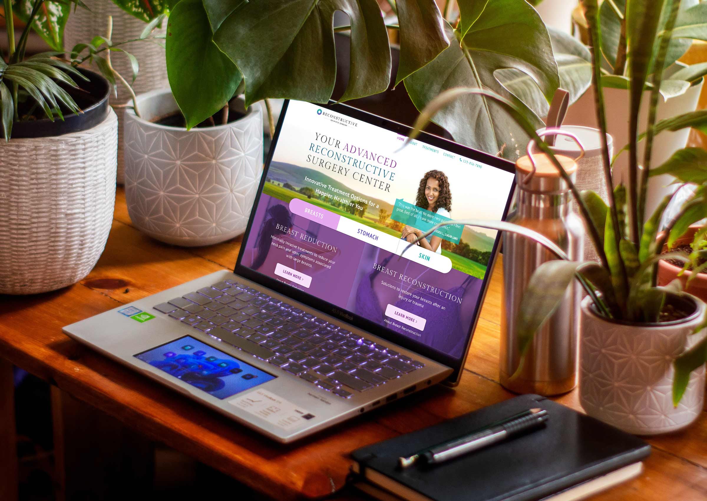 Laptop surrounded by plants showing Reconstructive Cosmetic Surgery website